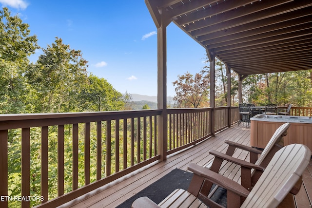 wooden deck featuring a hot tub