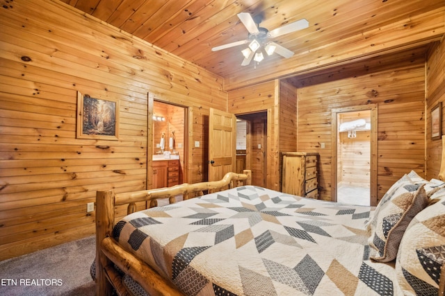 bedroom featuring wooden walls, carpet floors, connected bathroom, and wood ceiling