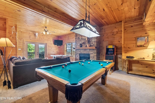 recreation room with wood ceiling, a stone fireplace, billiards, and carpet