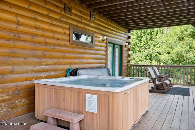 wooden deck with a hot tub