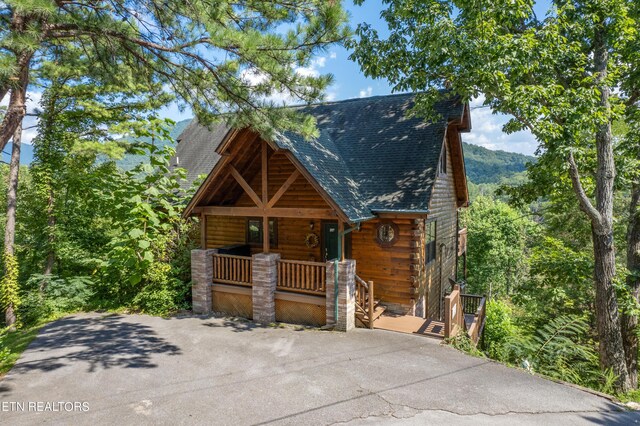 log cabin with covered porch