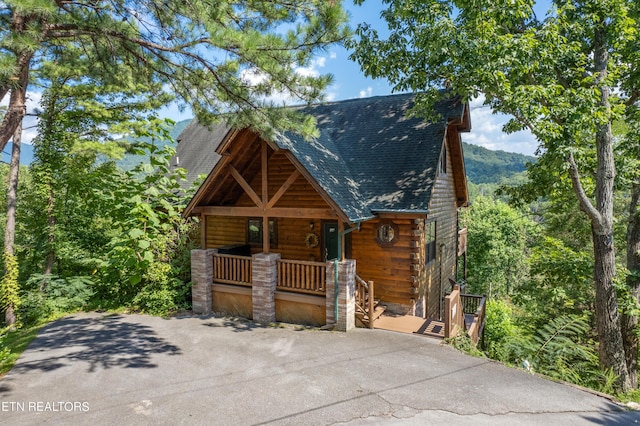 log-style house with a porch