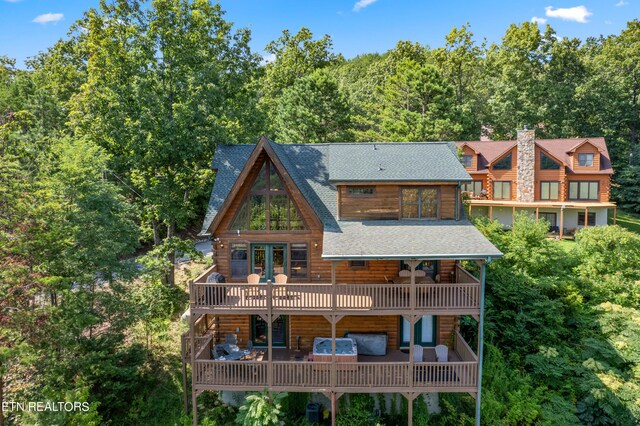 back of house featuring a balcony