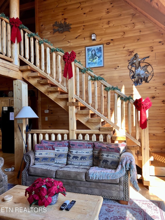 1424 Rocky Top Way, Townsend, TN 37882 - living area with wooden walls, wood finished floors, a high ceiling, and stairway