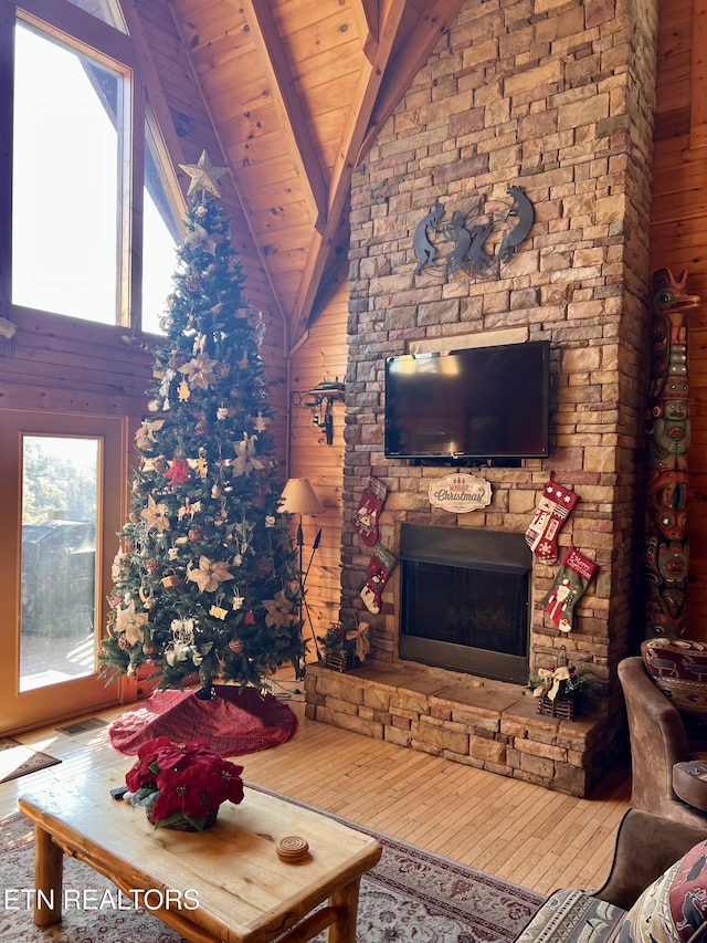 1424 Rocky Top Way, Townsend, TN 37882 - living room with wood walls, a stone fireplace, wood finished floors, and wooden ceiling