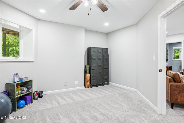 recreation room with carpet flooring, ceiling fan, and a healthy amount of sunlight