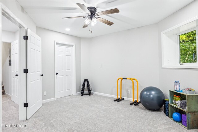 interior space featuring ceiling fan and light carpet