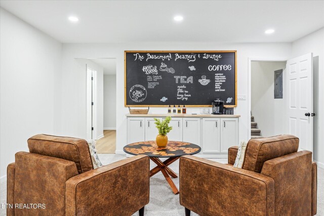 living room with electric panel and light hardwood / wood-style floors