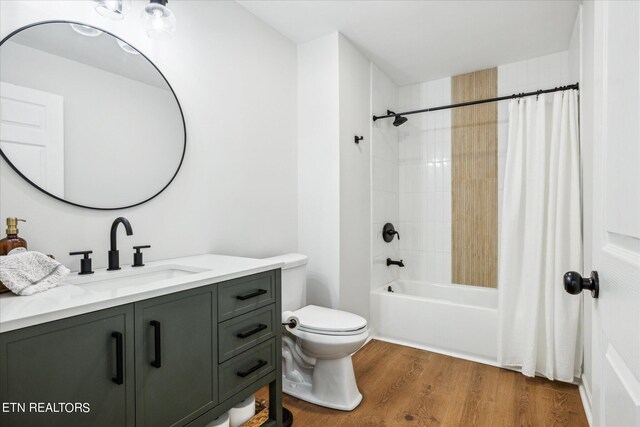 full bathroom featuring vanity, toilet, hardwood / wood-style flooring, and shower / bath combo