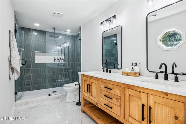 bathroom with dual bowl vanity, walk in shower, tile patterned flooring, and toilet