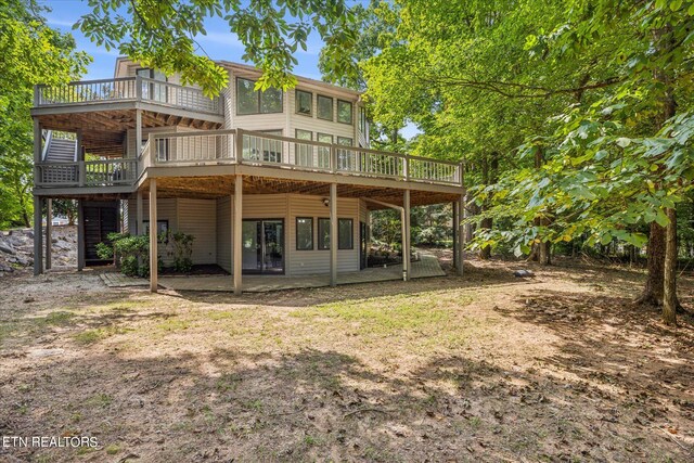 rear view of house with a wooden deck