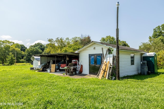 back of property featuring a yard