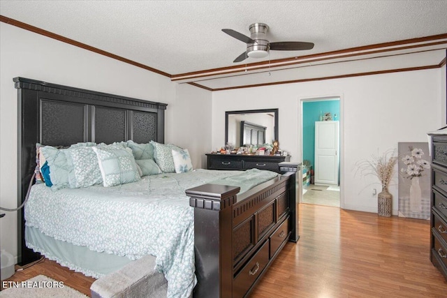 bedroom featuring a textured ceiling, ceiling fan, light wood finished floors, and crown molding