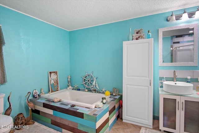 full bathroom with a textured ceiling, toilet, vanity, and a bath