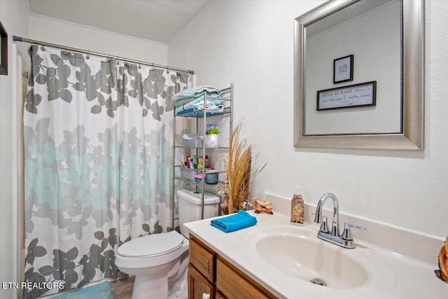 bathroom featuring curtained shower, vanity, toilet, and a textured ceiling