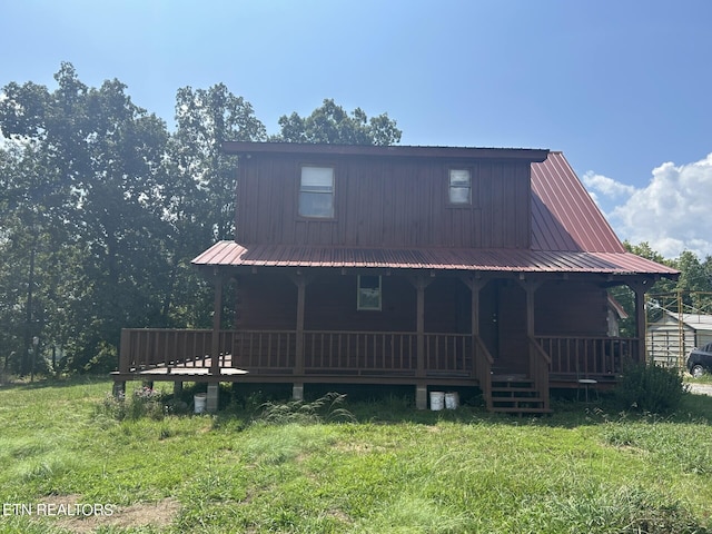 rear view of property with a yard