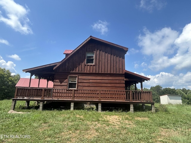 view of home's exterior featuring a wooden deck and a lawn