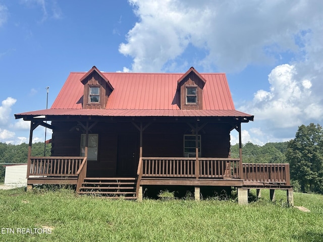 view of front of home with a front yard and a porch