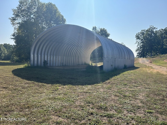 view of outdoor structure with a lawn