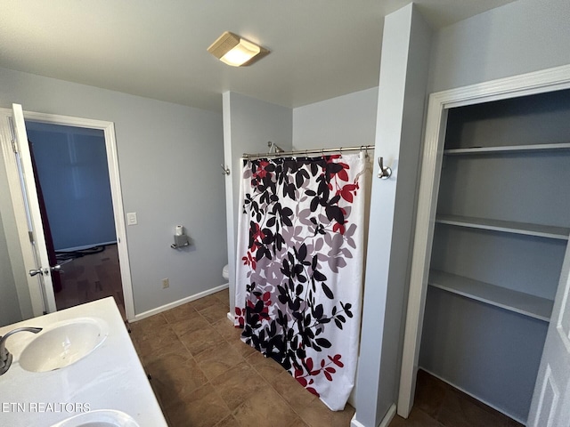 bathroom featuring toilet, a shower with curtain, tile patterned flooring, and vanity