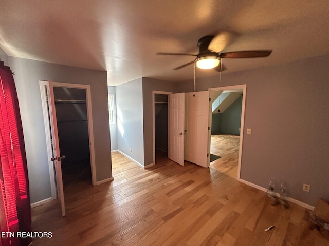 unfurnished bedroom with ceiling fan and hardwood / wood-style flooring