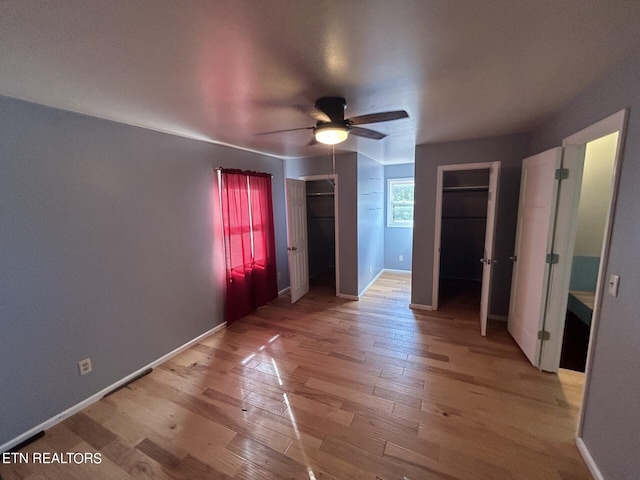 unfurnished bedroom featuring ceiling fan and light hardwood / wood-style floors