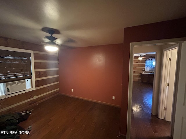 unfurnished room with ceiling fan, dark hardwood / wood-style flooring, and cooling unit