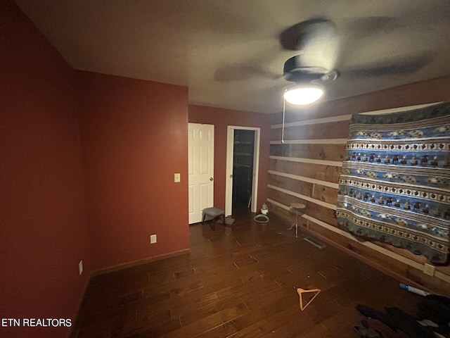 unfurnished room with ceiling fan and dark hardwood / wood-style floors