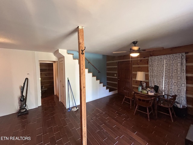 living room with ceiling fan and dark wood-type flooring