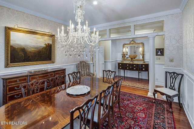 dining area with a chandelier, ornamental molding, decorative columns, and wood-type flooring