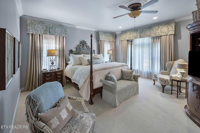 carpeted bedroom featuring ceiling fan and ornamental molding