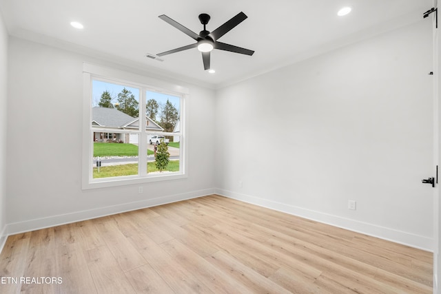 empty room with light wood-style flooring, baseboards, and visible vents