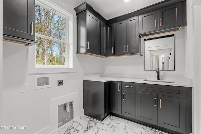 washroom with hookup for an electric dryer, marble finish floor, hookup for a washing machine, cabinet space, and a sink