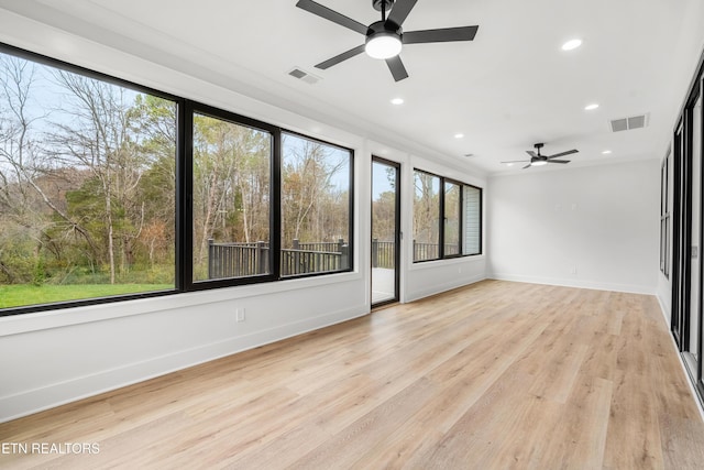 spare room with baseboards, recessed lighting, light wood-style floors, and visible vents