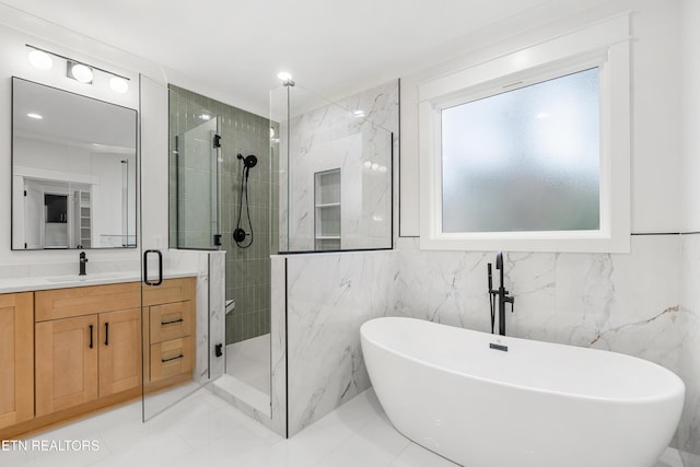 bathroom with tiled shower, vanity, and a freestanding tub