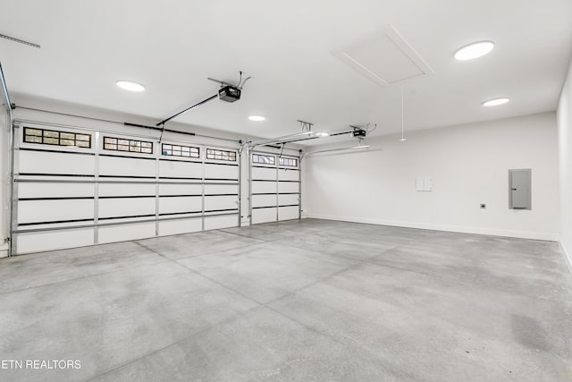 garage featuring electric panel, baseboards, and a garage door opener