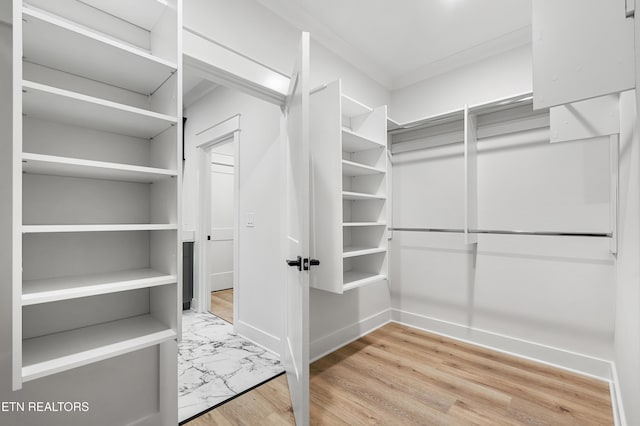 spacious closet featuring wood finished floors