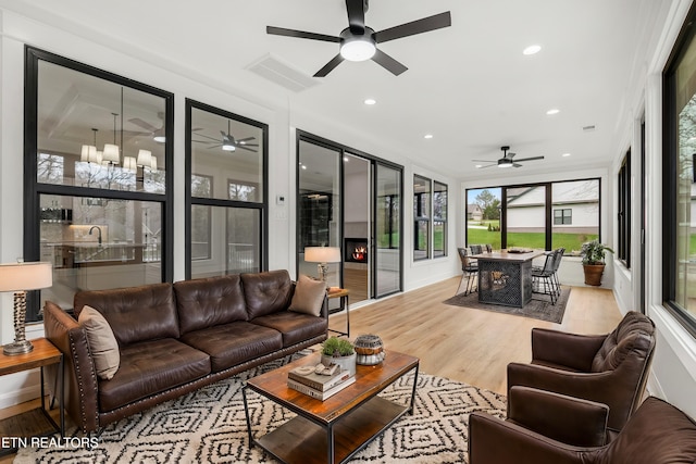 sunroom / solarium with visible vents and a chandelier