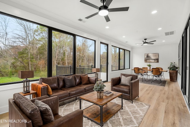 sunroom / solarium featuring visible vents and ceiling fan