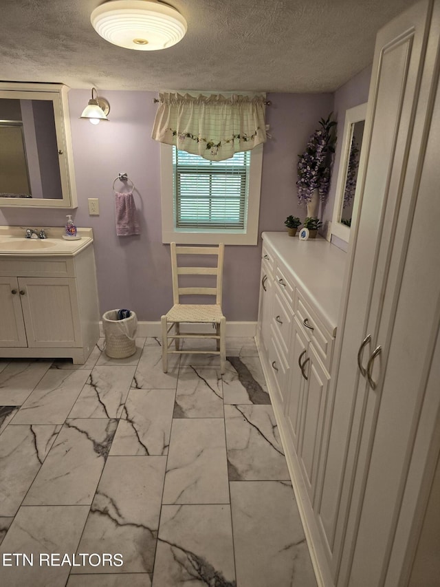 bathroom with vanity and a textured ceiling