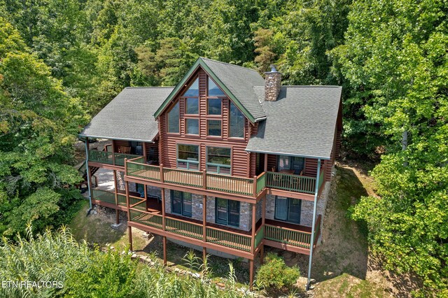 rear view of house featuring a deck