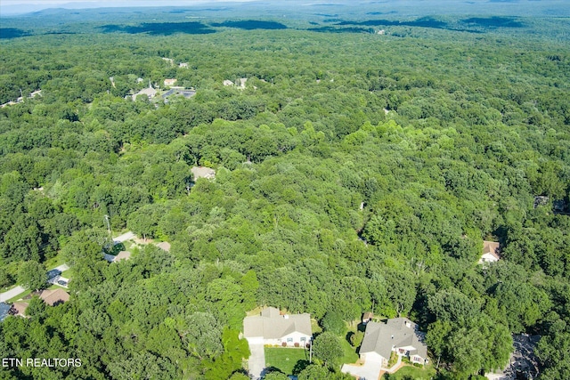 birds eye view of property with a wooded view