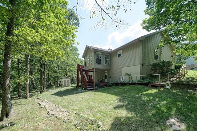 back of house with a storage unit, a lawn, and an outdoor structure