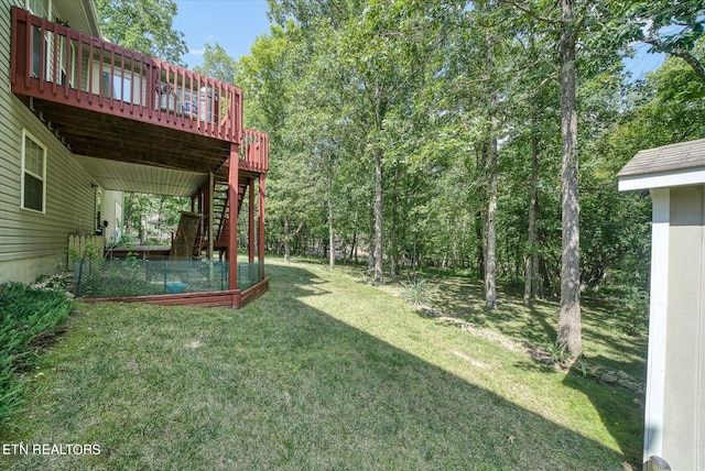 view of yard featuring a deck and stairway
