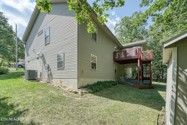 view of home's exterior with central AC, stairway, a wooden deck, and a lawn