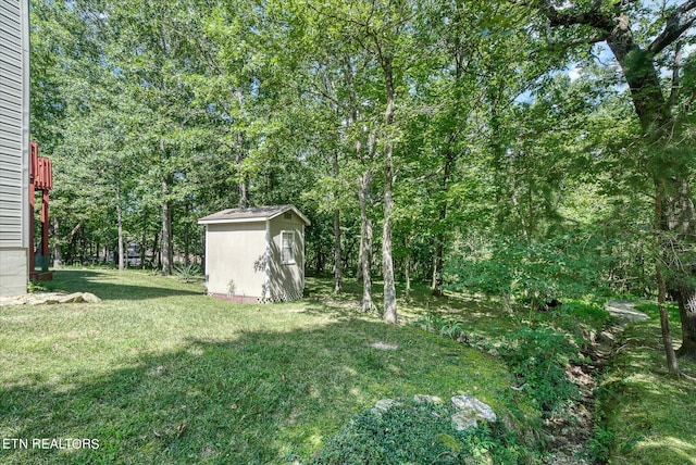 view of yard with a storage shed and an outbuilding