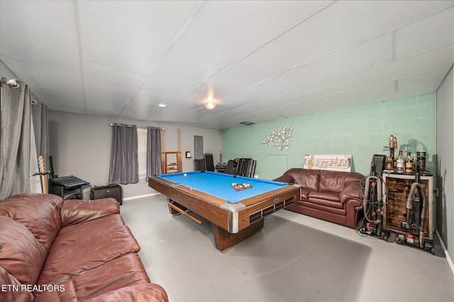 recreation room featuring concrete flooring, pool table, and concrete block wall