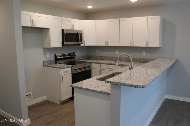 kitchen featuring white cabinetry, kitchen peninsula, dark wood-type flooring, light stone countertops, and electric stove