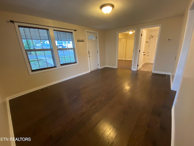 unfurnished room with dark hardwood / wood-style floors