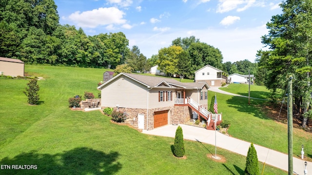 view of front of property featuring a garage and a front lawn